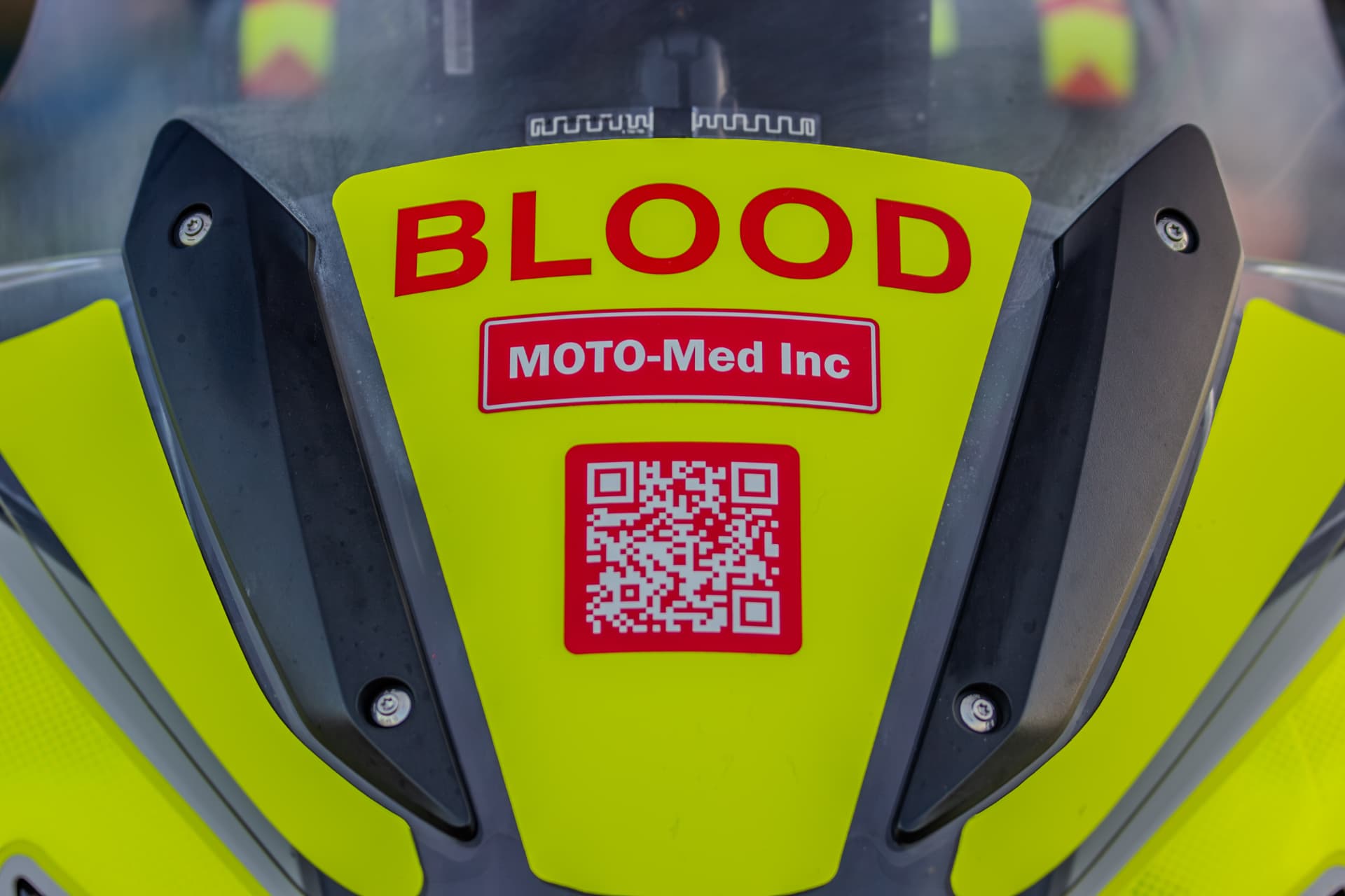 BLOOD and Moto-Med Inc. markings on the fairing of a medical courier motorcycle